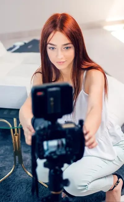 Teenage girl setting up a webcam.